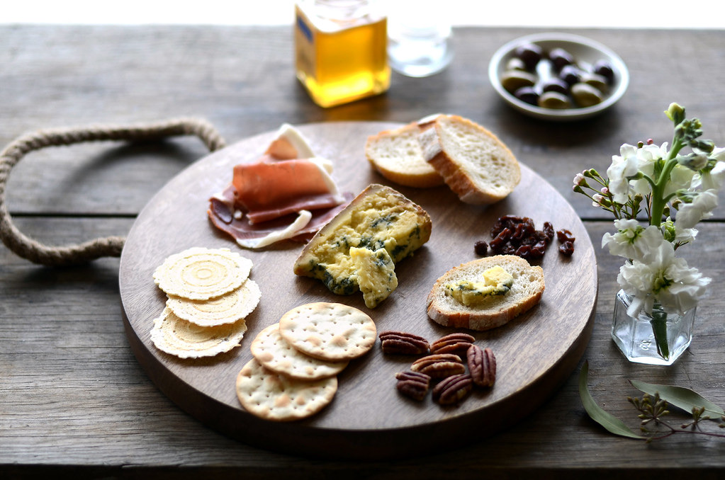 A farm table with fresh yogurt, honey, bread and cheese.
